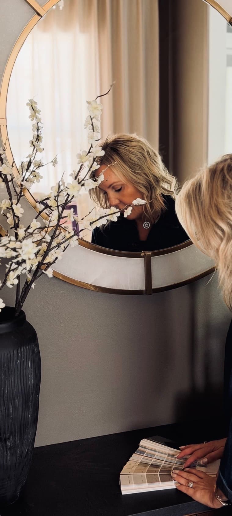 Sherrie Funk reviewing paint swatches during an interior styling consultation